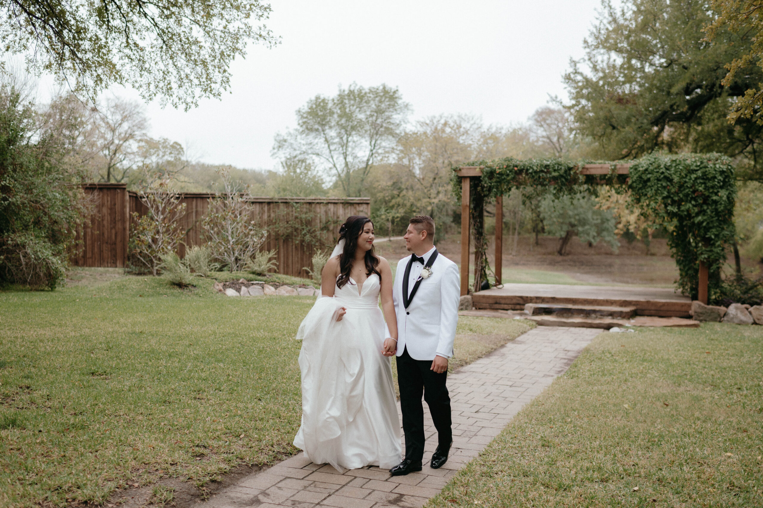 bride and groom walking taken by DFW Wedding Photographer Nicole Endress Photography