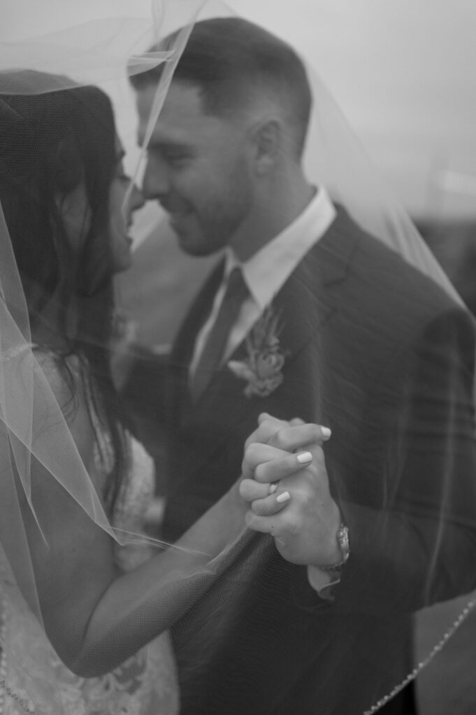 bride and groom under the veil taken by DFW wedding photographer Nicole Endress Photography