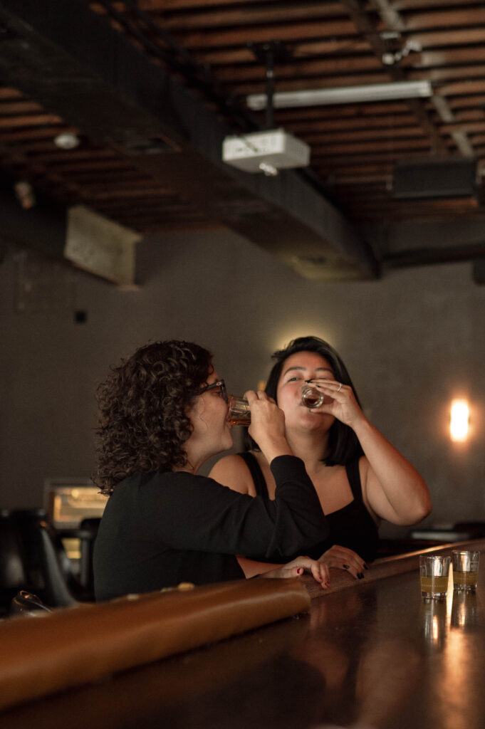 Couple taking shots in Fort Worth, TX taken by Nicole Endress Photography