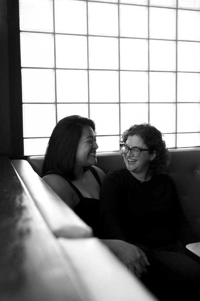 couple chatting in a bar taken by DFW wedding photographer Nicole Endress Photography