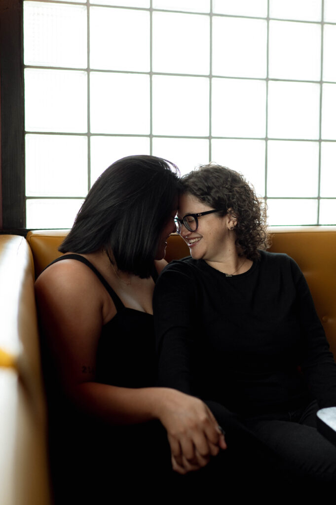 couple in a bar booth taken by DFW wedding photographer Nicole Endress Photography