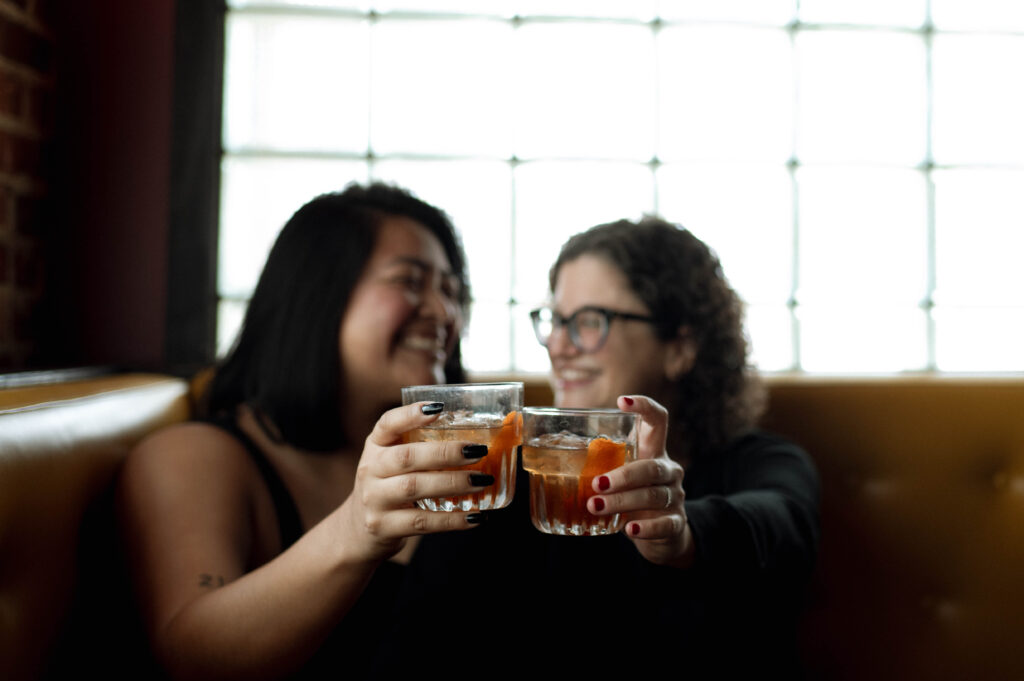 couple having drinks in Nickel City taken by DFW wedding photographer Nicole Endress Photography