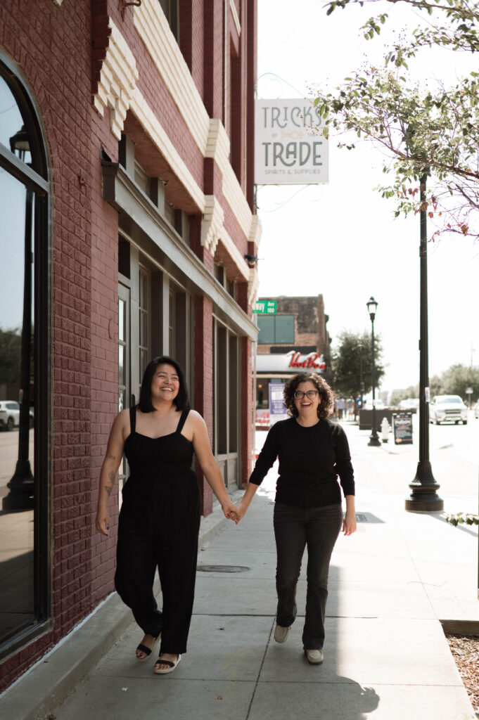 couple walking down the sidewalk taken by DFW wedding photographer Nicole Endress Photography