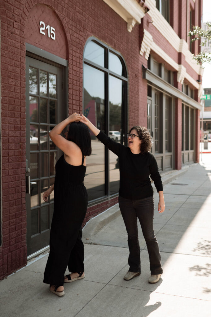 couple dancing on the sidewalk taken by DFW wedding photographer Nicole Endress Photography