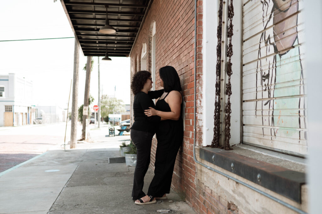 couple cuddling in the city taken by DFW wedding photographer Nicole Endress Photography