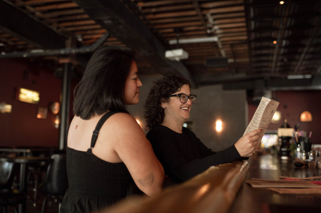 Couple looking at drink menu at Nickel City in Fort Worth, TX taken by Nicole Endress Photography