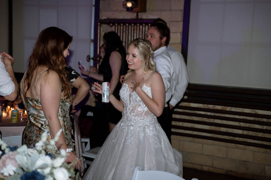 bride talking to wedding guest by DFW Wedding Photographer 