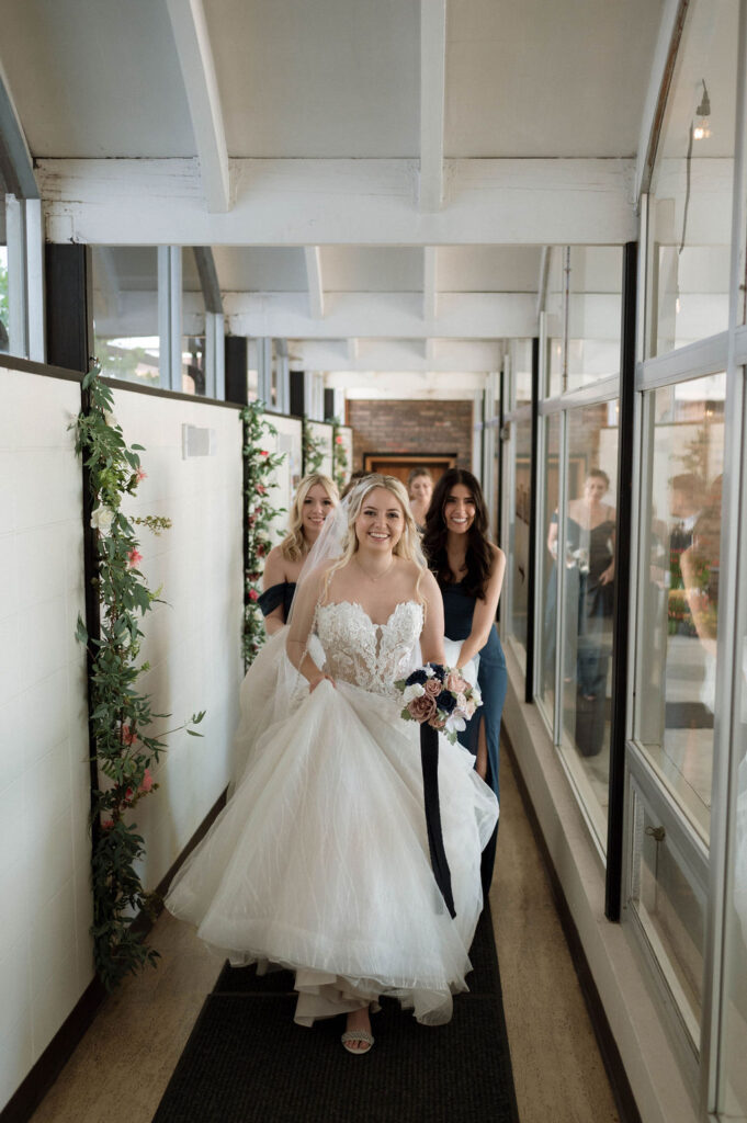 bride walking with her bridesmaids by Illinois wedding photographer 