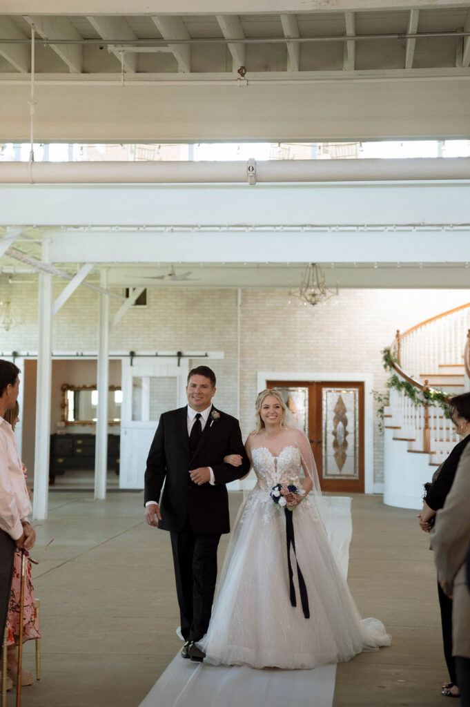 bride walking down the aisle with her father by Illinois wedding photographer