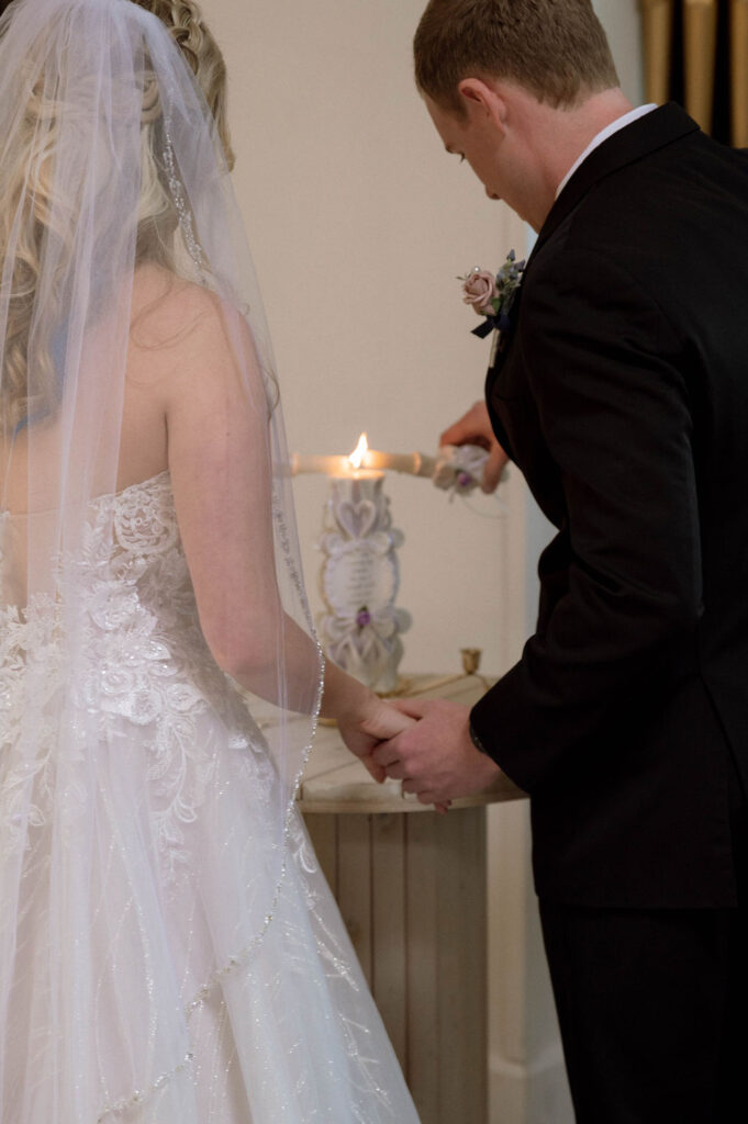 bride & groom lighting unity candle by Illinois wedding photographer