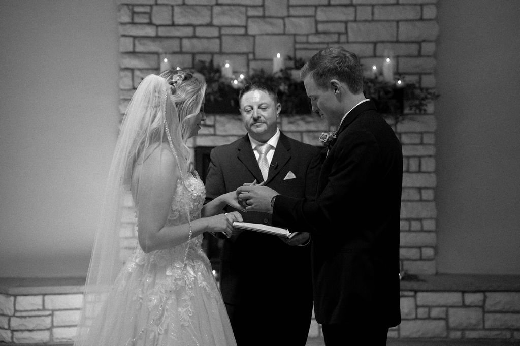 bride & groom exchanging rings by Illinois wedding photographer