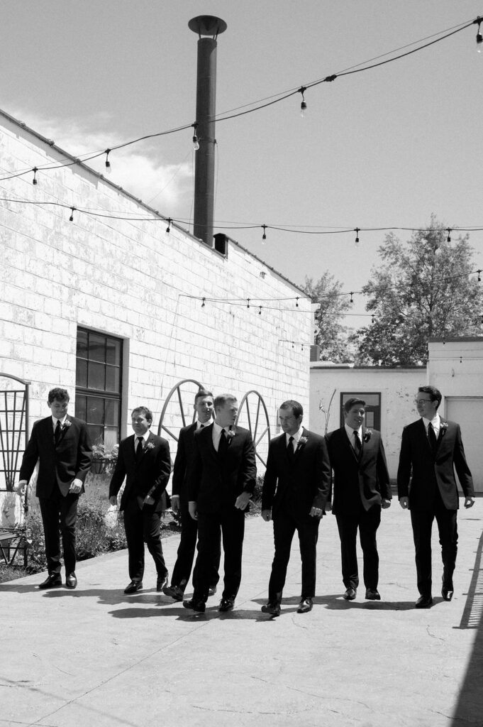 groomsmen walking by Illinois wedding photographer