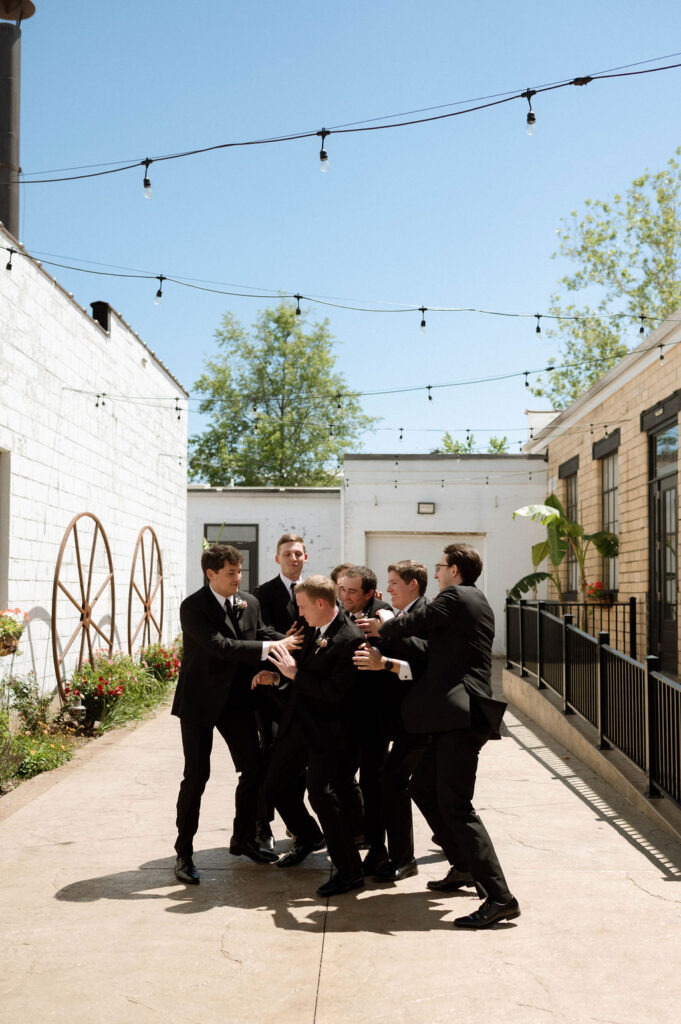 groom and groomsmen messing around by Illinois wedding photographer