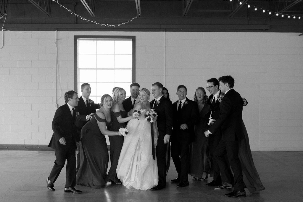 wedding party hugging bride & groom by DFW Wedding Photographer 