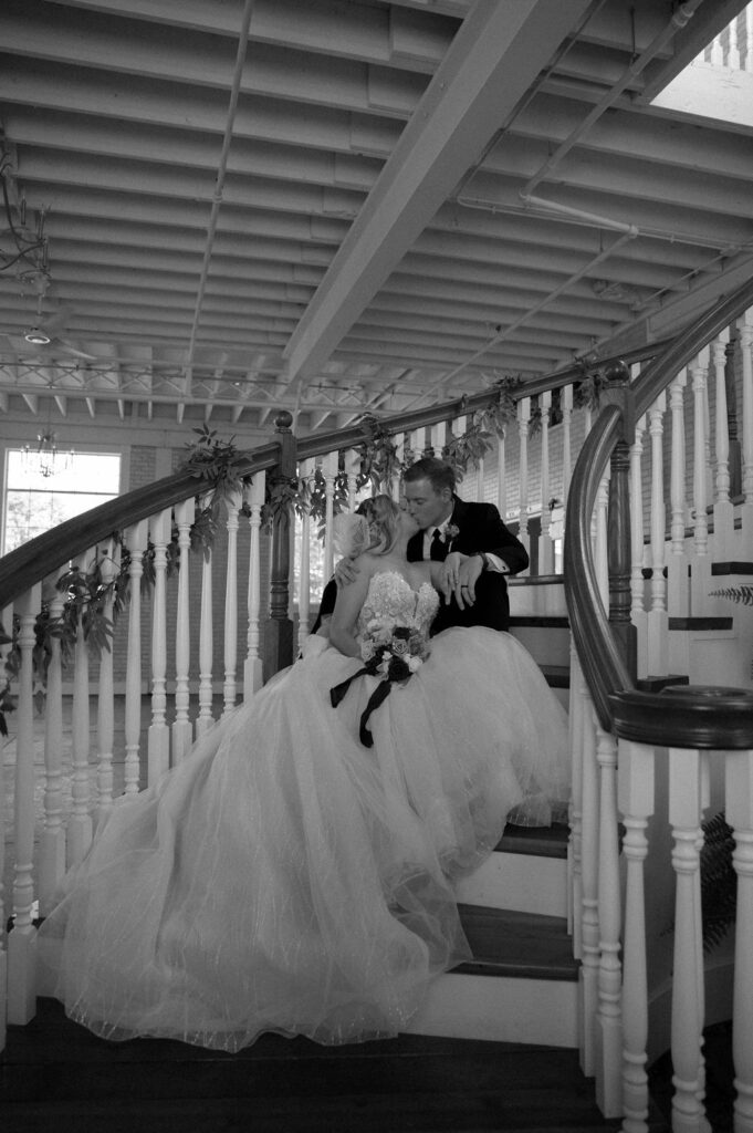 bride & groom sitting on grand staircase by Illinois wedding photographer