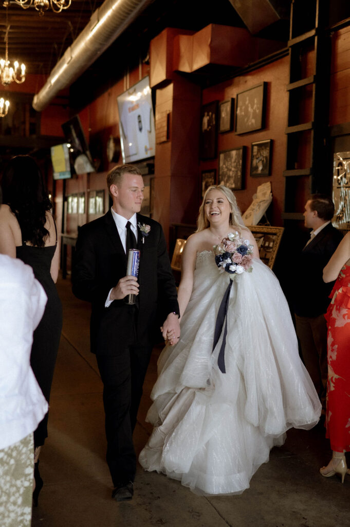 bride and groom entering reception