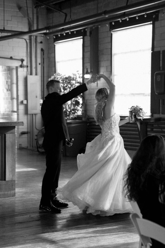 bride & groom spinning by Illinois wedding photographer