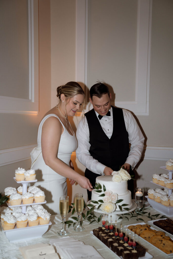 bride and groom cutting cake taken by Dallas Wedding Photographer Nicole Endress Photography