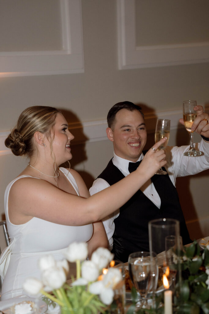 champagne cheers for bride and groom taken by Dallas Wedding Photographer Nicole Endress Photography