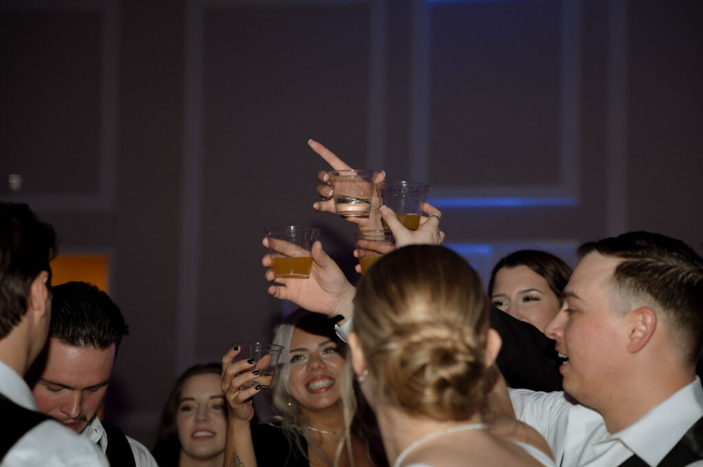 reception cheers taken by Dallas Wedding Photographer Nicole Endress Photography