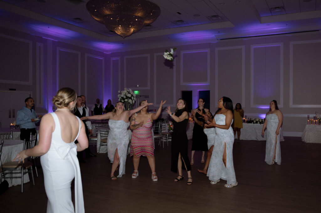 bouquet toss taken by Dallas Wedding Photographer Nicole Endress Photography