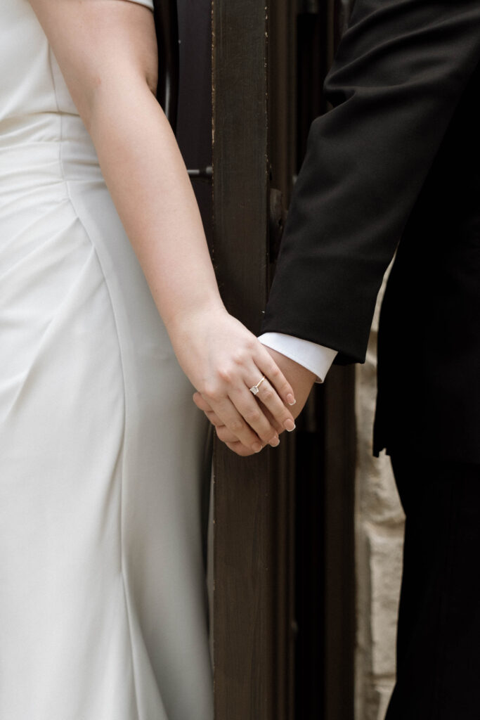 bride & groom holding hands during first touch taken by Dallas Wedding Photographer Nicole Endress Photography