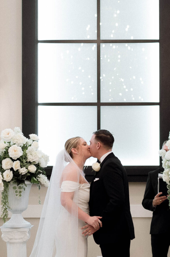 bride and groom first kiss taken by Dallas Wedding Photographer Nicole Endress Photography