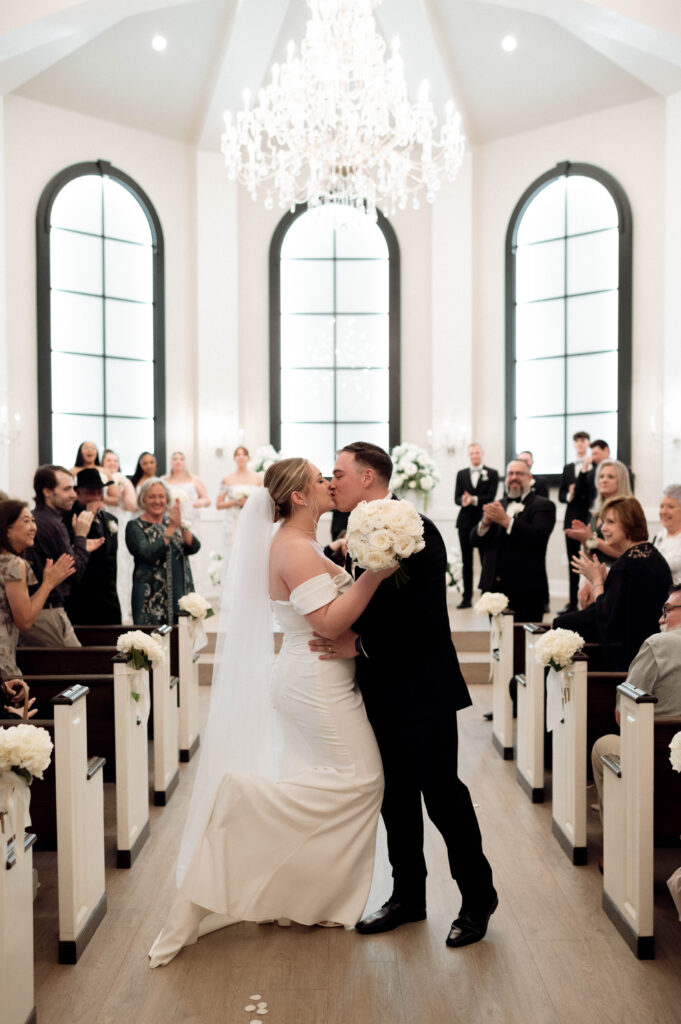 ceremony aisle kiss taken by Dallas Wedding Photographer Nicole Endress Photography