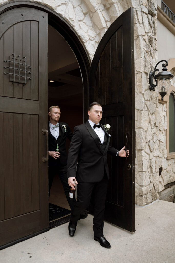 groomsmen walking out the door taken by Dallas Wedding Photographer Nicole Endress Photography