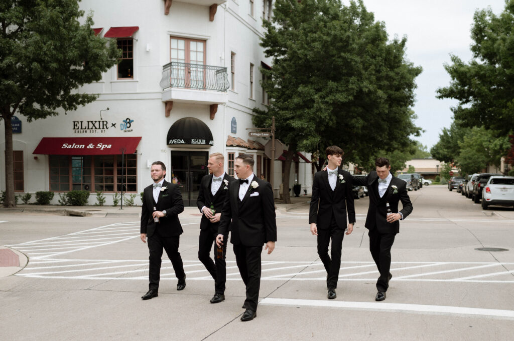 groom & groomsmen walking taken by Dallas Wedding Photographer Nicole Endress Photography