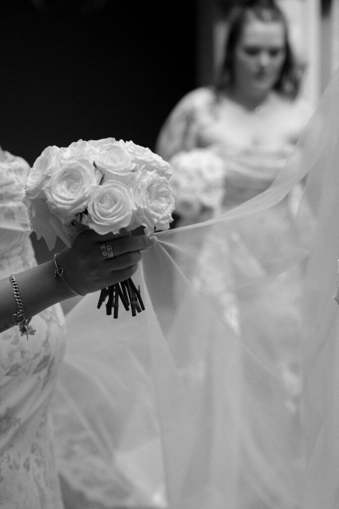 bridesmaid carrying veil taken by Dallas Wedding Photographer Nicole Endress Photography