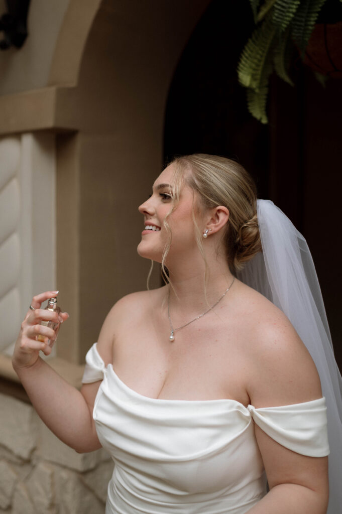 bride spraying perfume taken by Dallas Wedding Photographer Nicole Endress Photography