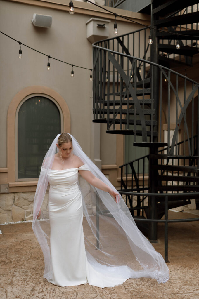 bride holding her veil taken by Dallas Wedding Photographer Nicole Endress Photography