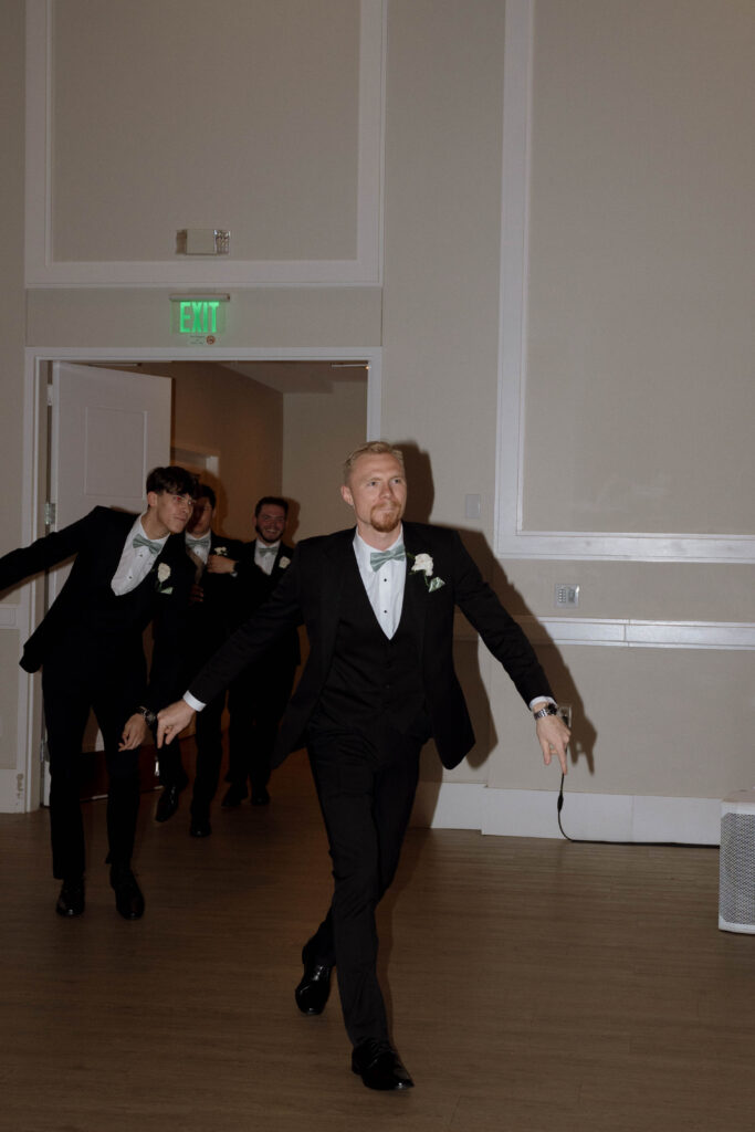 groomsmen entering reception taken by Dallas Wedding Photographer Nicole Endress Photography