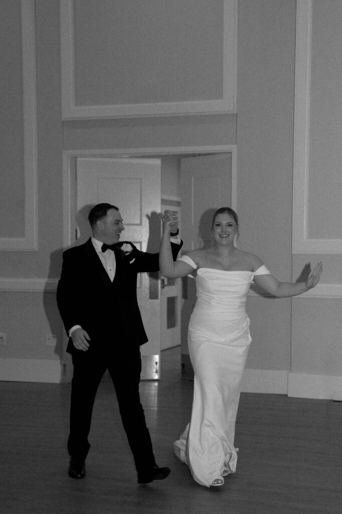 bride and groom entering reception taken by Dallas Wedding Photographer Nicole Endress Photography