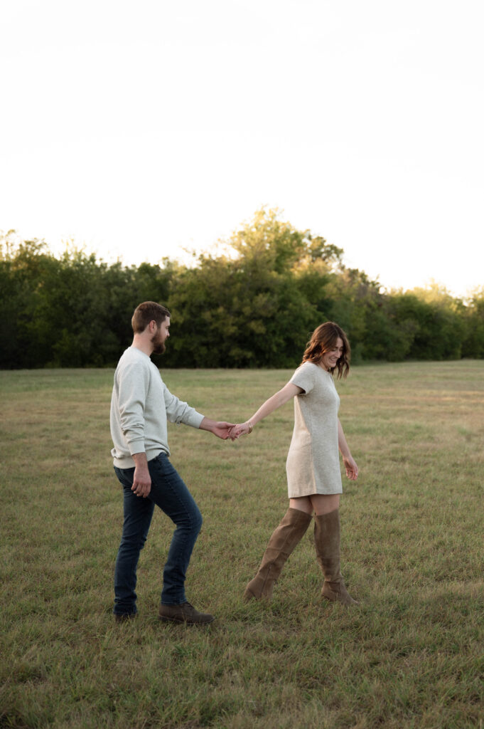 Couple holding hands during engagement photos in Fort Worth