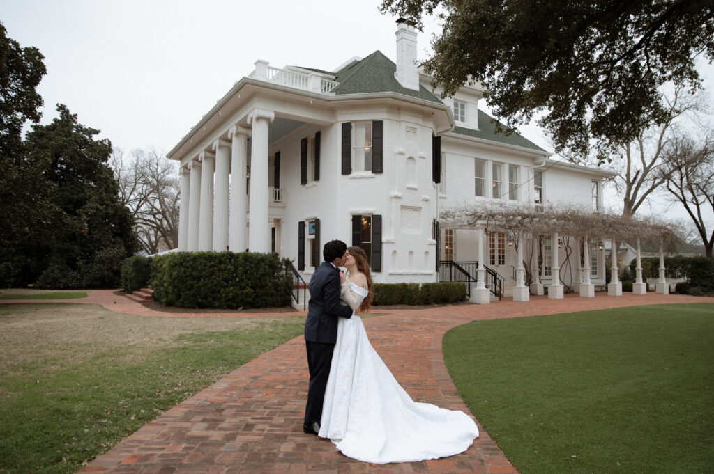 photo of bride and groom taken in front of Woodbine Mansion by best Austin Wedding photographer Nicole Endress Photography