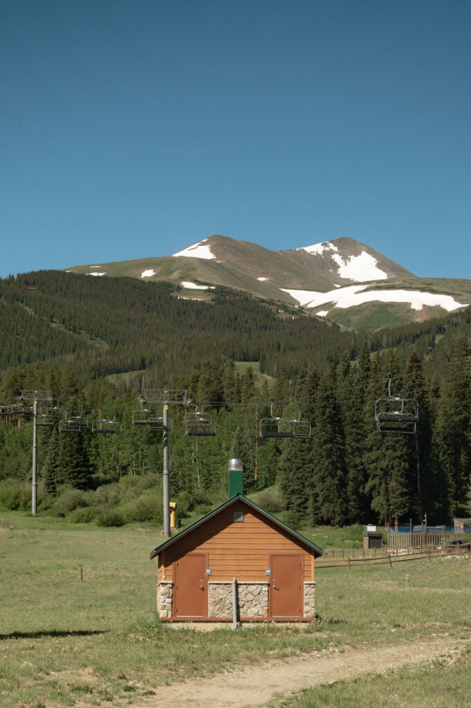 View of snow-patched mountain peaks and ski lift at Breckenridge Resort near TenMile Station - capturing the charm of a Colorado mountain wedding venue.
