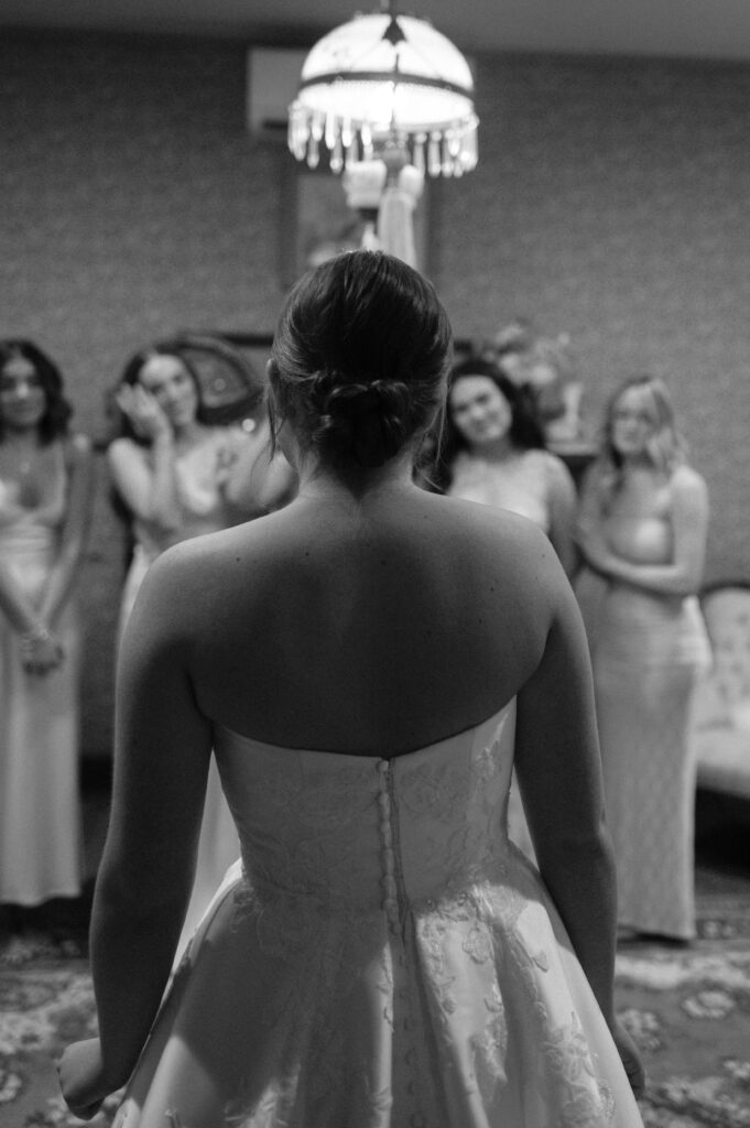 bridesmaids first look at the bride at Chapel at Chestnut Square in McKinney, TX