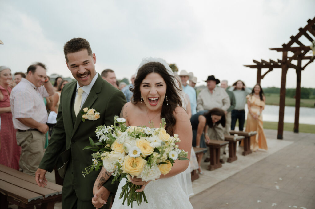 bride and groom walking down the aisle after just getting married taken by Dallas Wedding Photographer