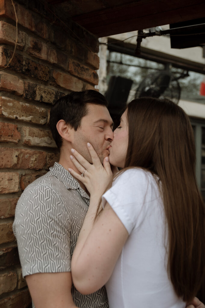 Couple kissing outside a pub taken by Dallas Wedding Photographer