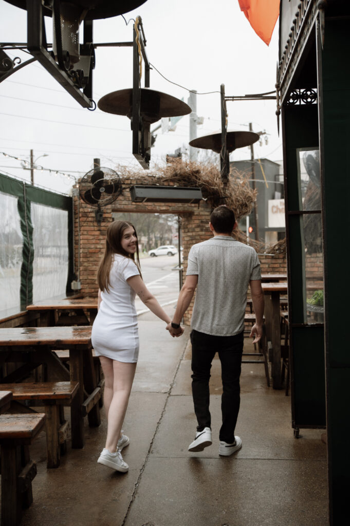 cute couple waking together in the rain