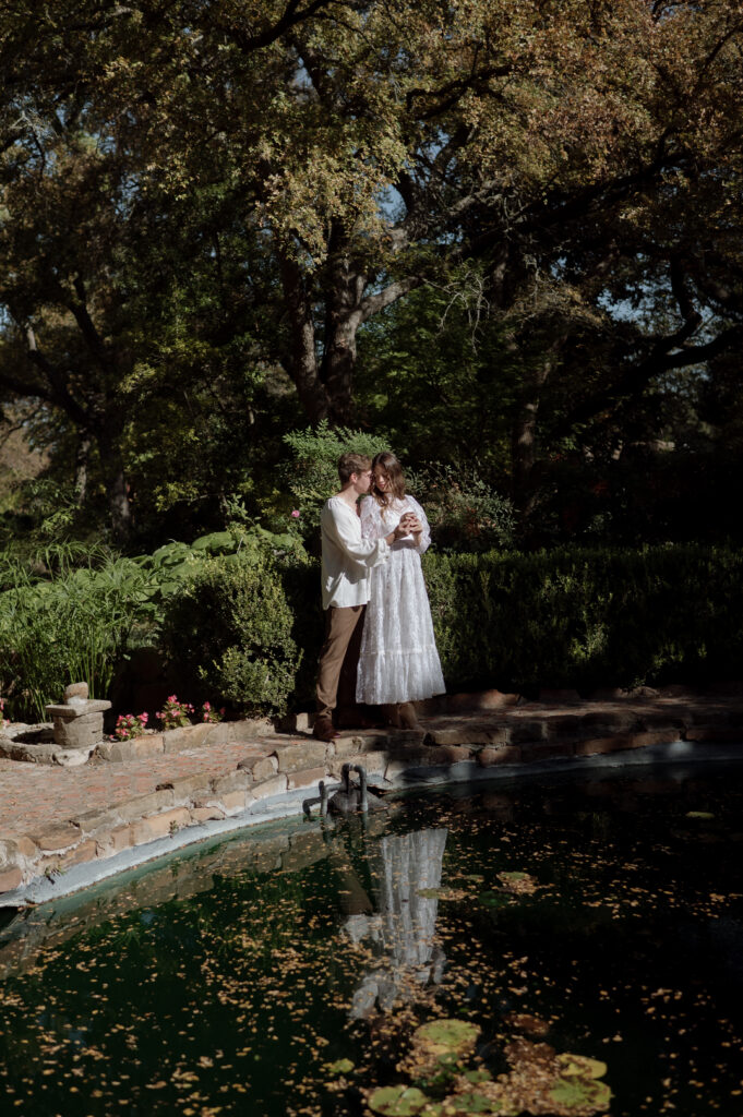 bride and groom embracing at Chandor Gardens in Weatherford, TX