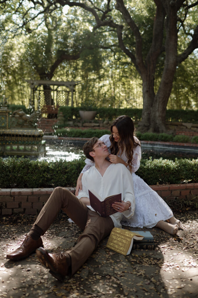bride and groom reading a book together in the garden taken by Dallas Wedding Photographer