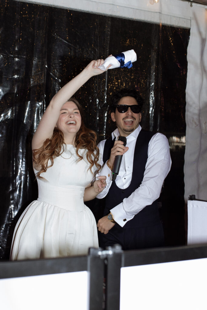 bride and groom in the DJ booth