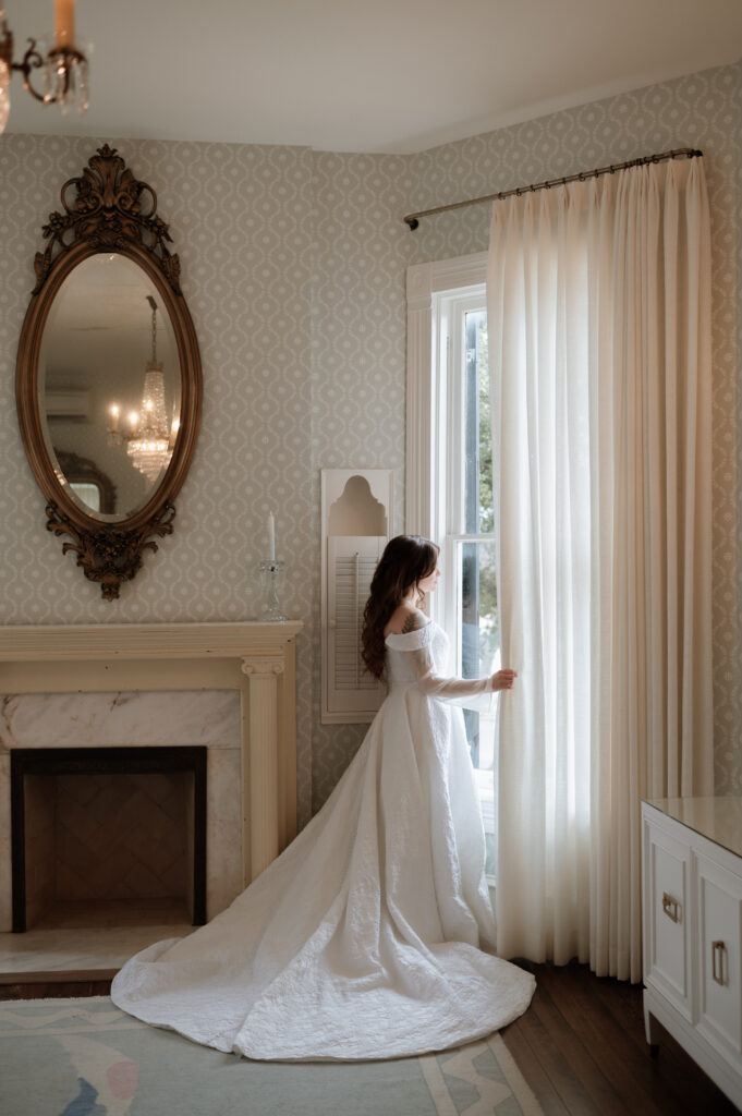 bride looking out window at Woodbine Mansion