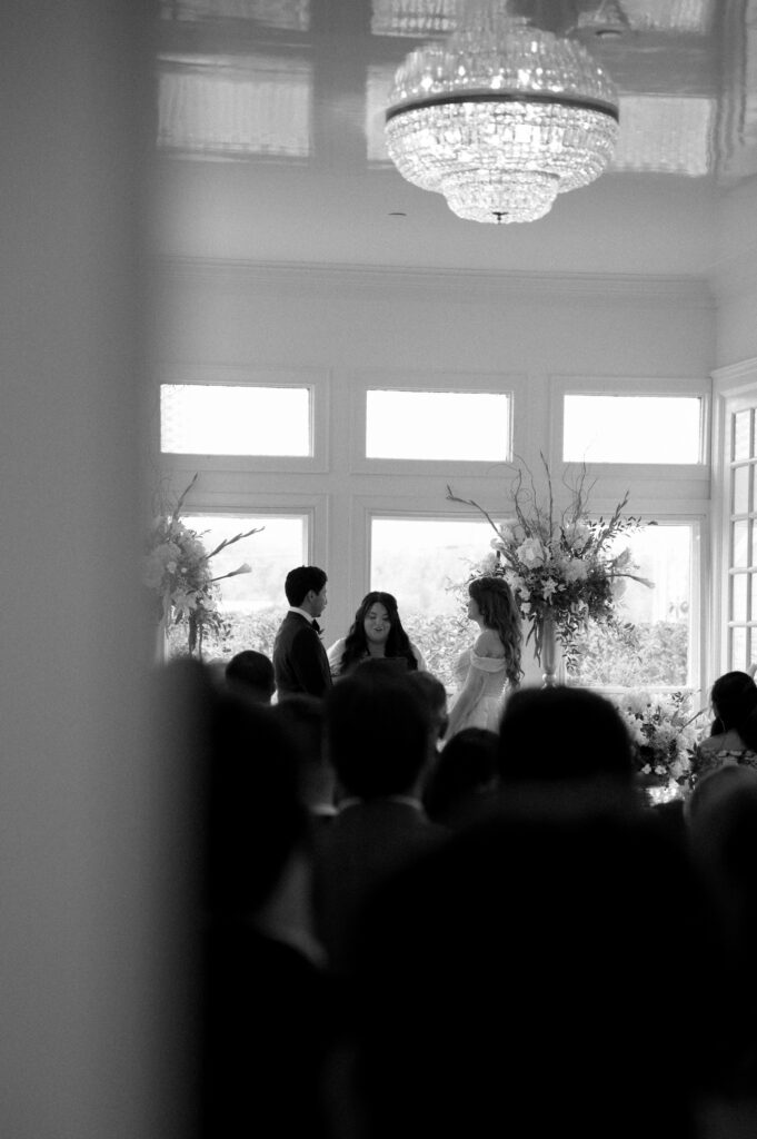 black and white photo of bride and groom during their wedding ceremony at Woodbine Mansion