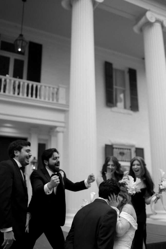 wedding party cheering on the bride and groom kissing taken by Austin Wedding Photographer