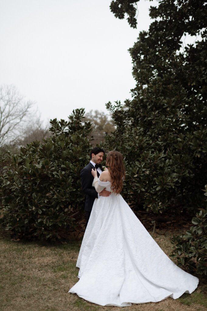 bride and groom in front of magnolia tree at Woodbine Mansion