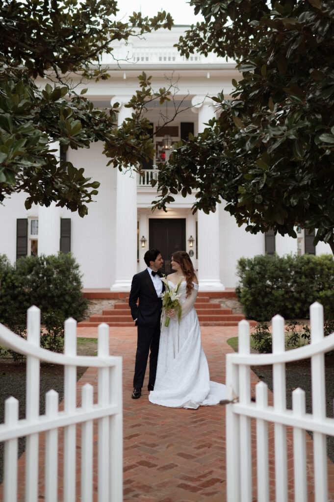 bride and groom photo in front of Woodbine Mansion taken by Nicole Endress Photography